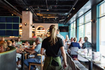 A group of people sitting at tables in a restaurant