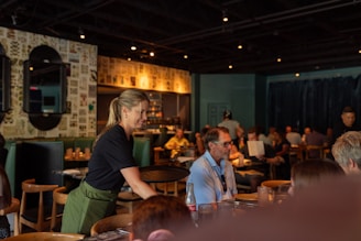 A group of people sitting at tables in a restaurant