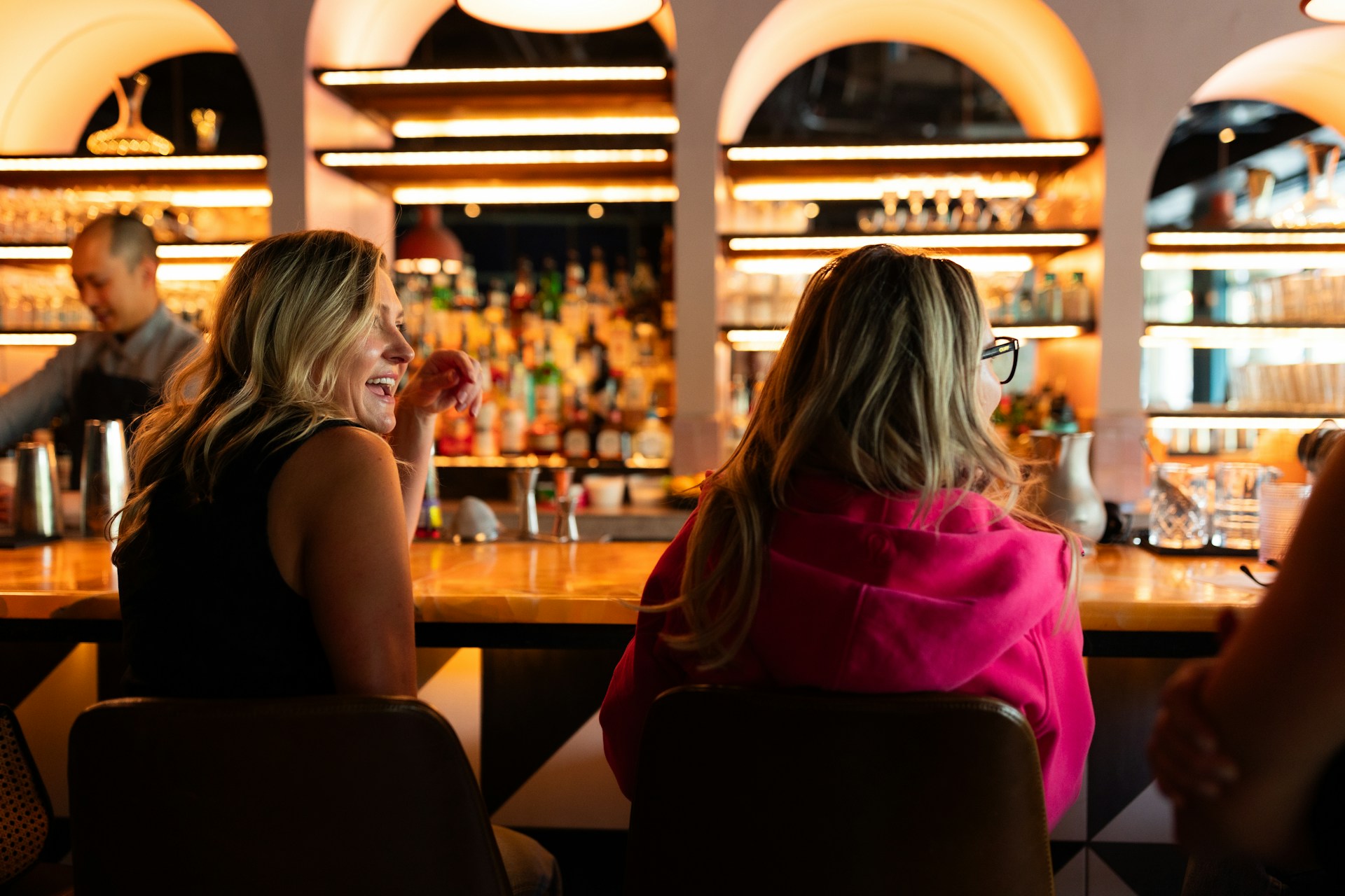 A group of people sitting at a bar