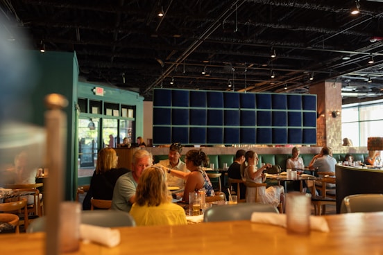 A group of people sitting at tables in a restaurant