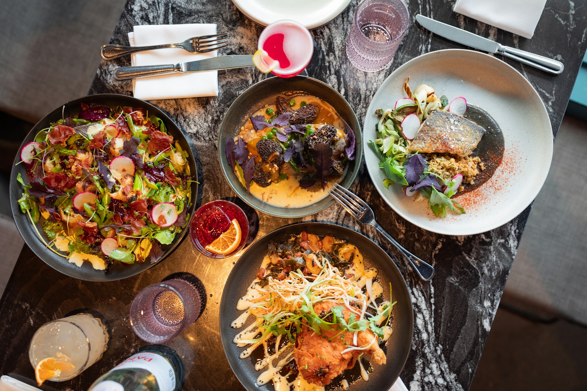 A table topped with plates and bowls of food