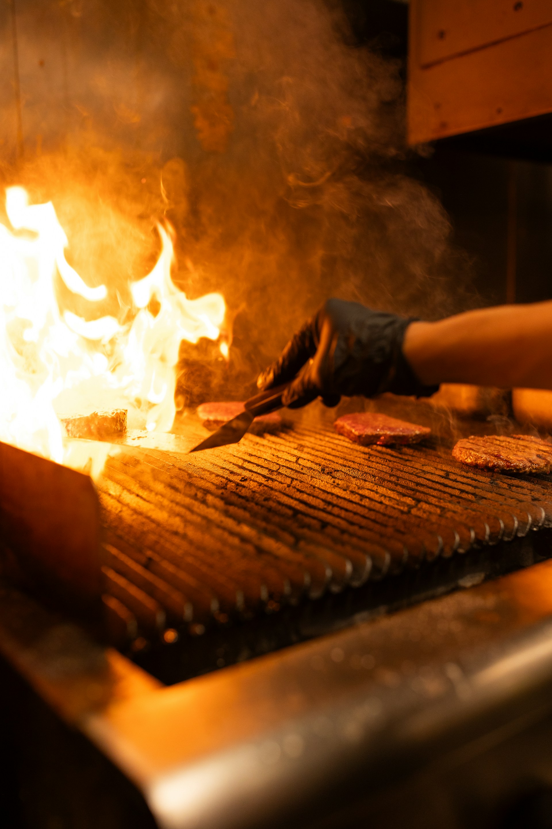 A person is cooking some food on a grill