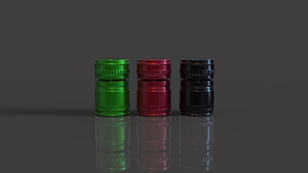 A group of three different colored bottles sitting next to each other