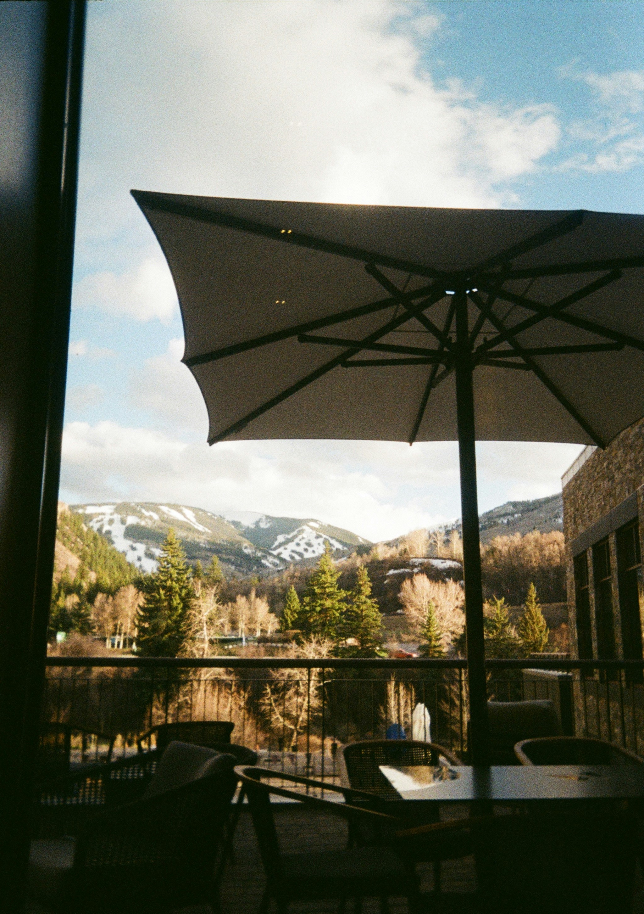 A patio with a table and chairs and an umbrella