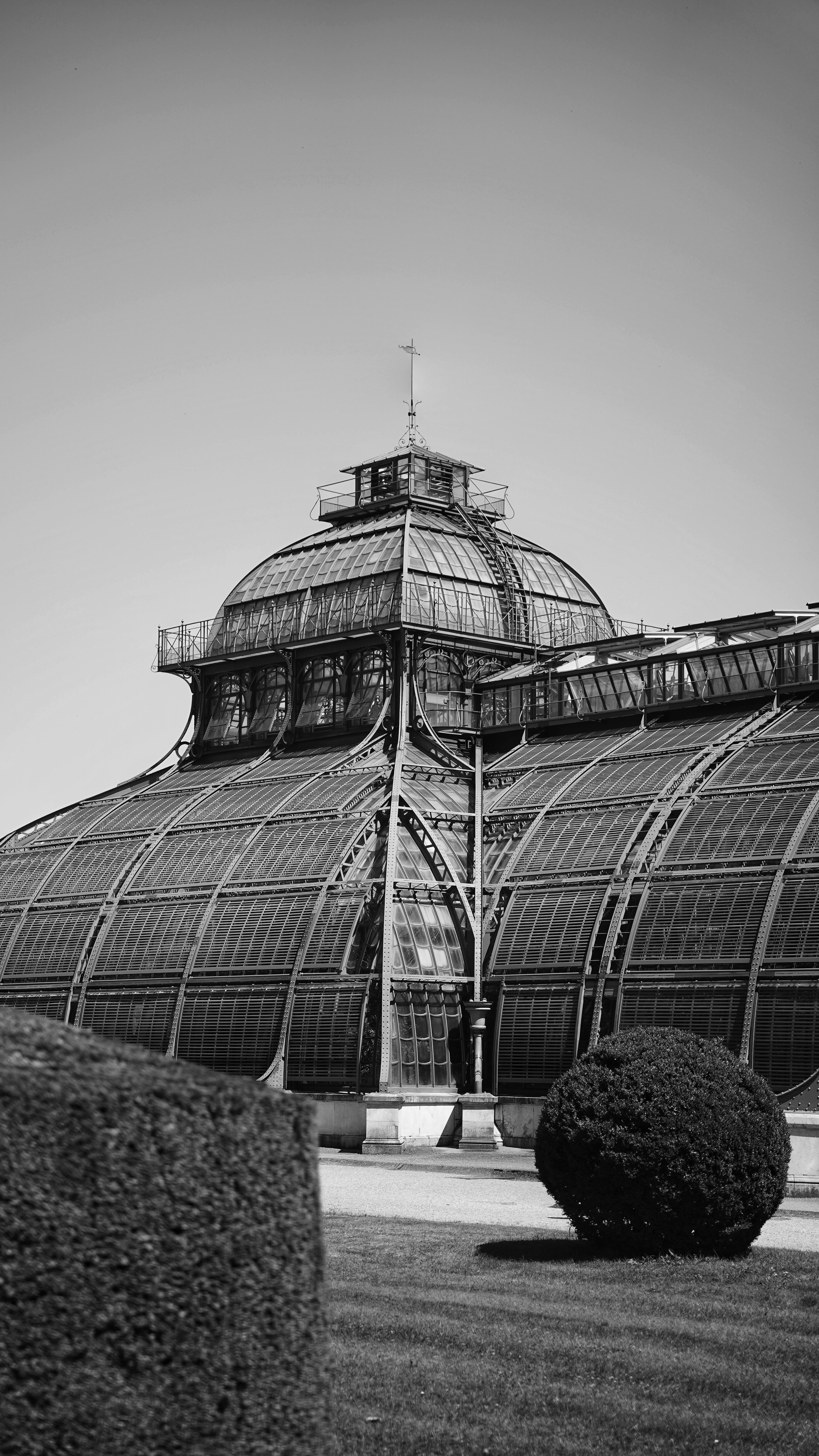A black and white photo of a large glass building