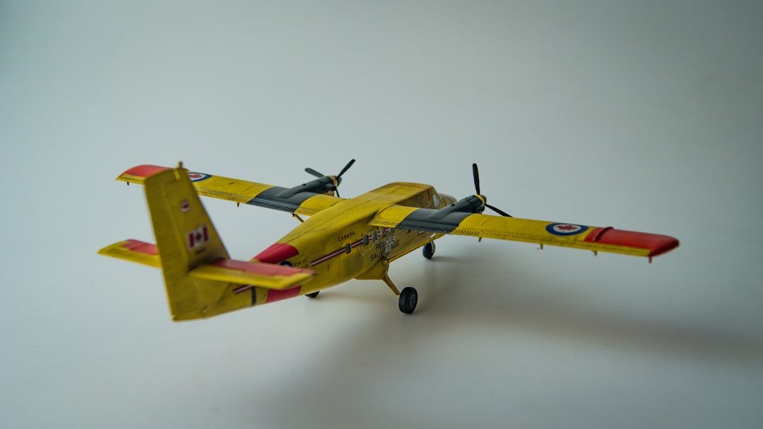 A yellow and red model airplane on a white surface,