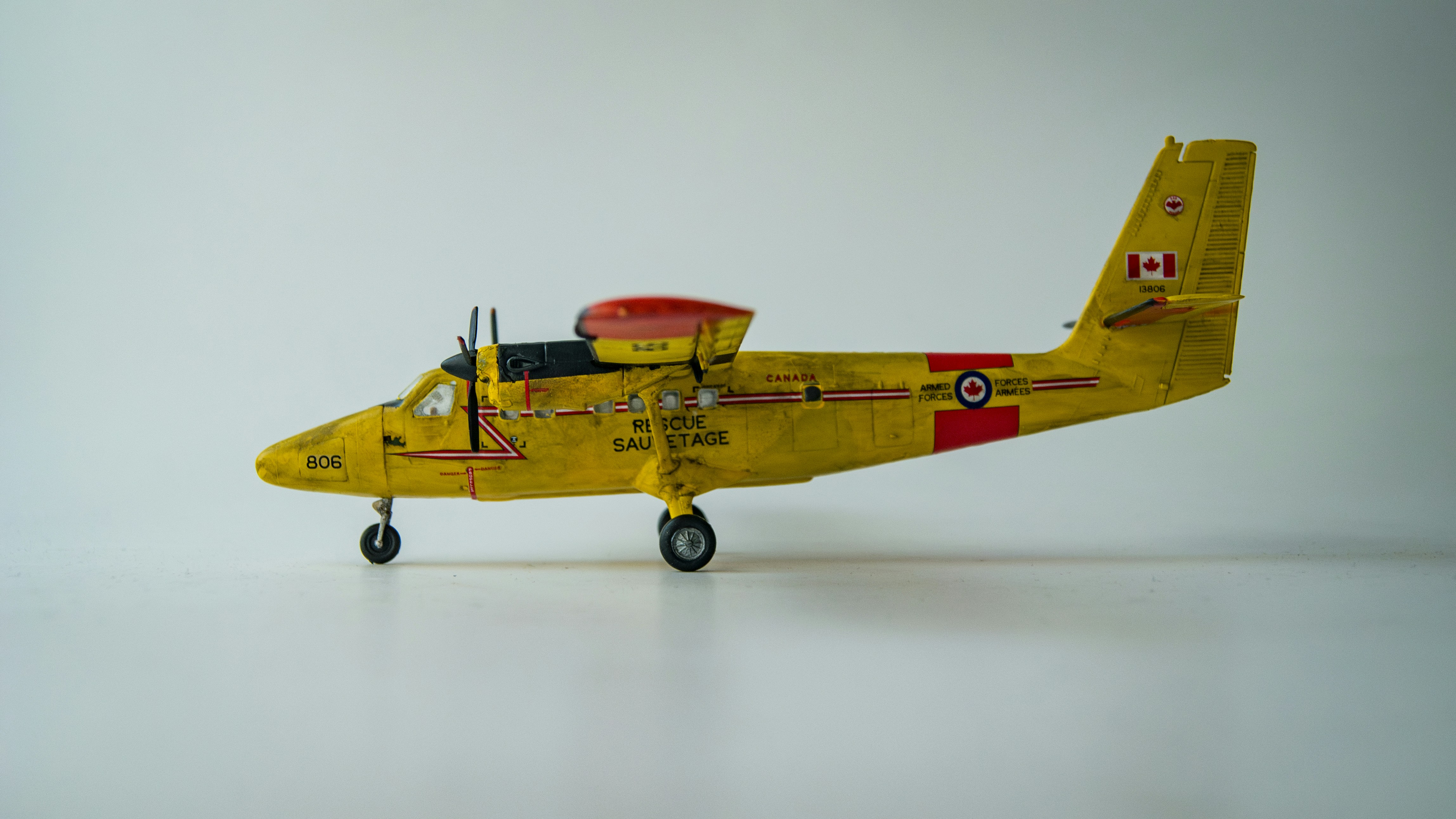 A yellow toy airplane sitting on top of a white table