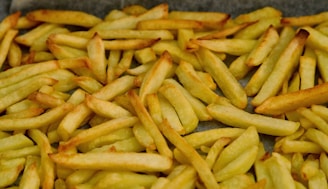 A pile of french fries sitting on top of a table