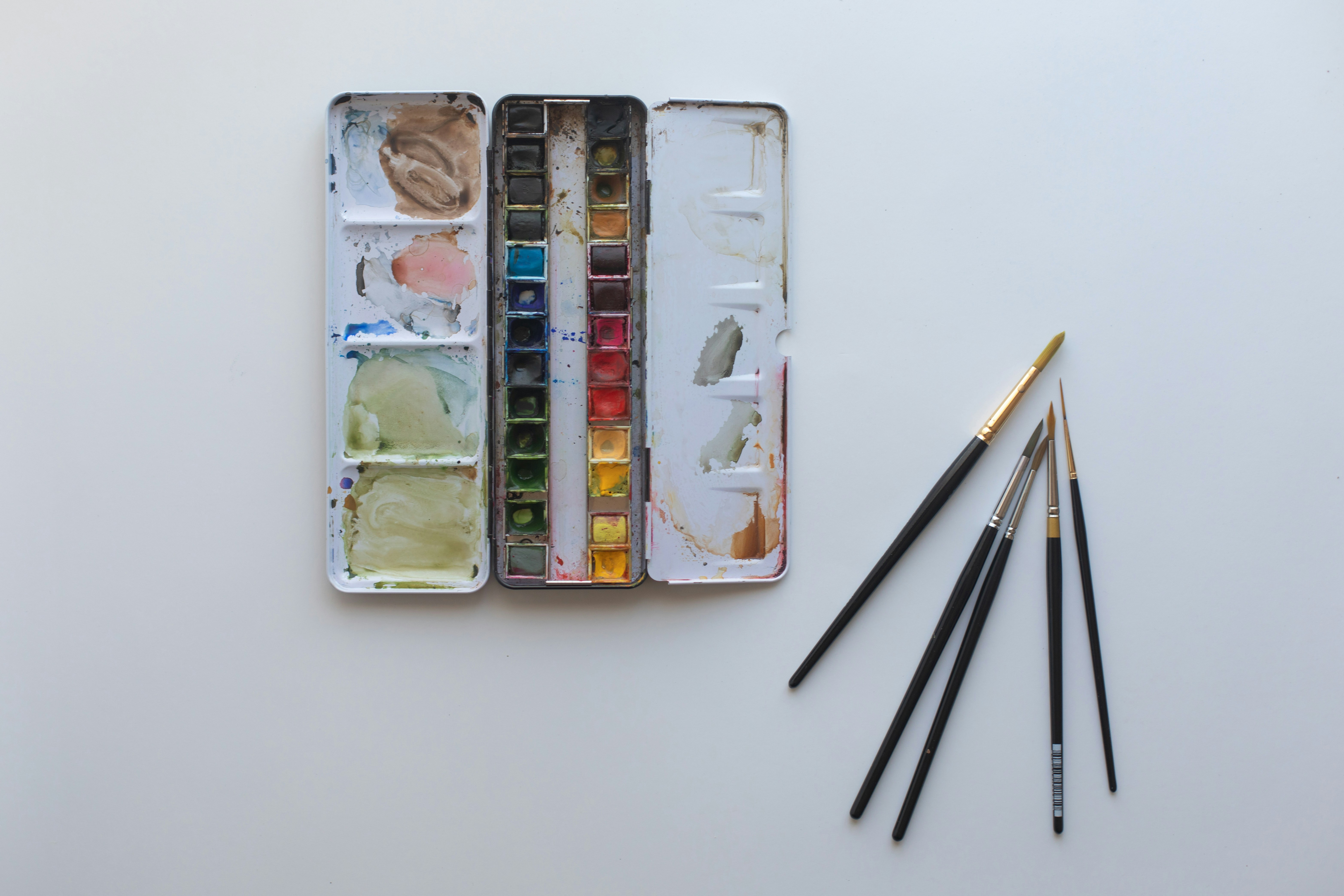 A box of watercolors and a set of brushes