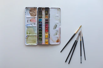 A box of watercolors and a set of brushes