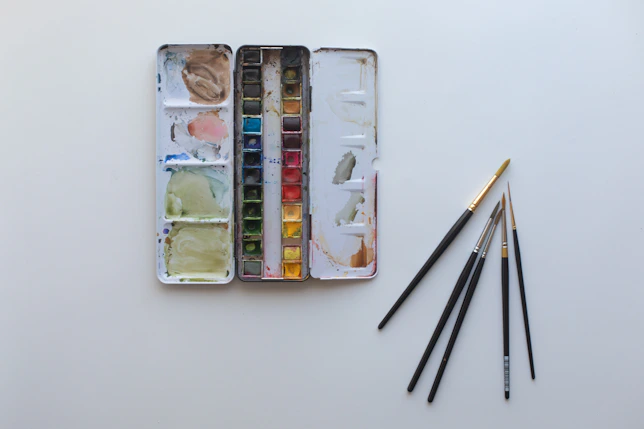 A box of watercolors and a set of brushes
