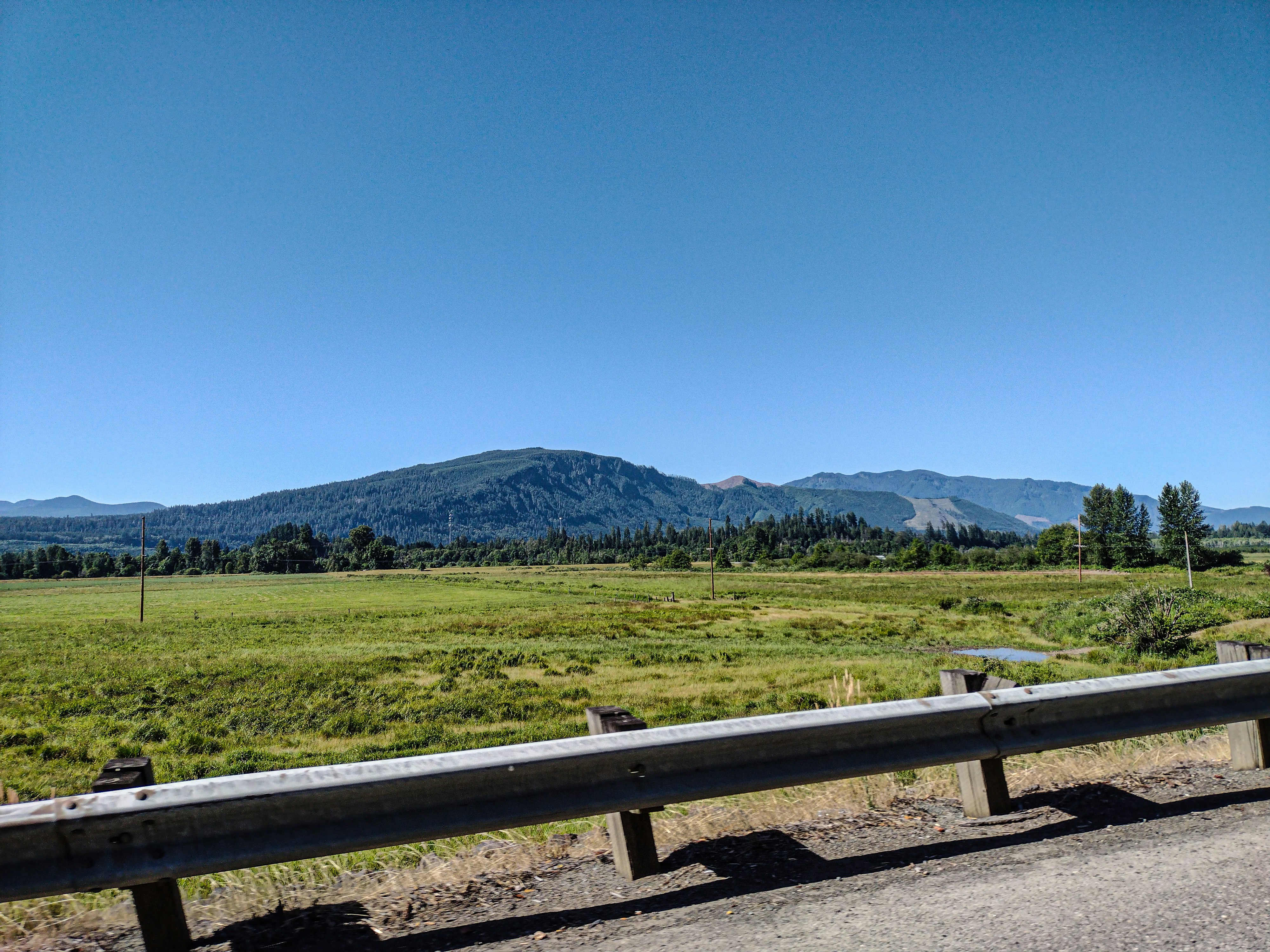 A bench sitting on the side of a road