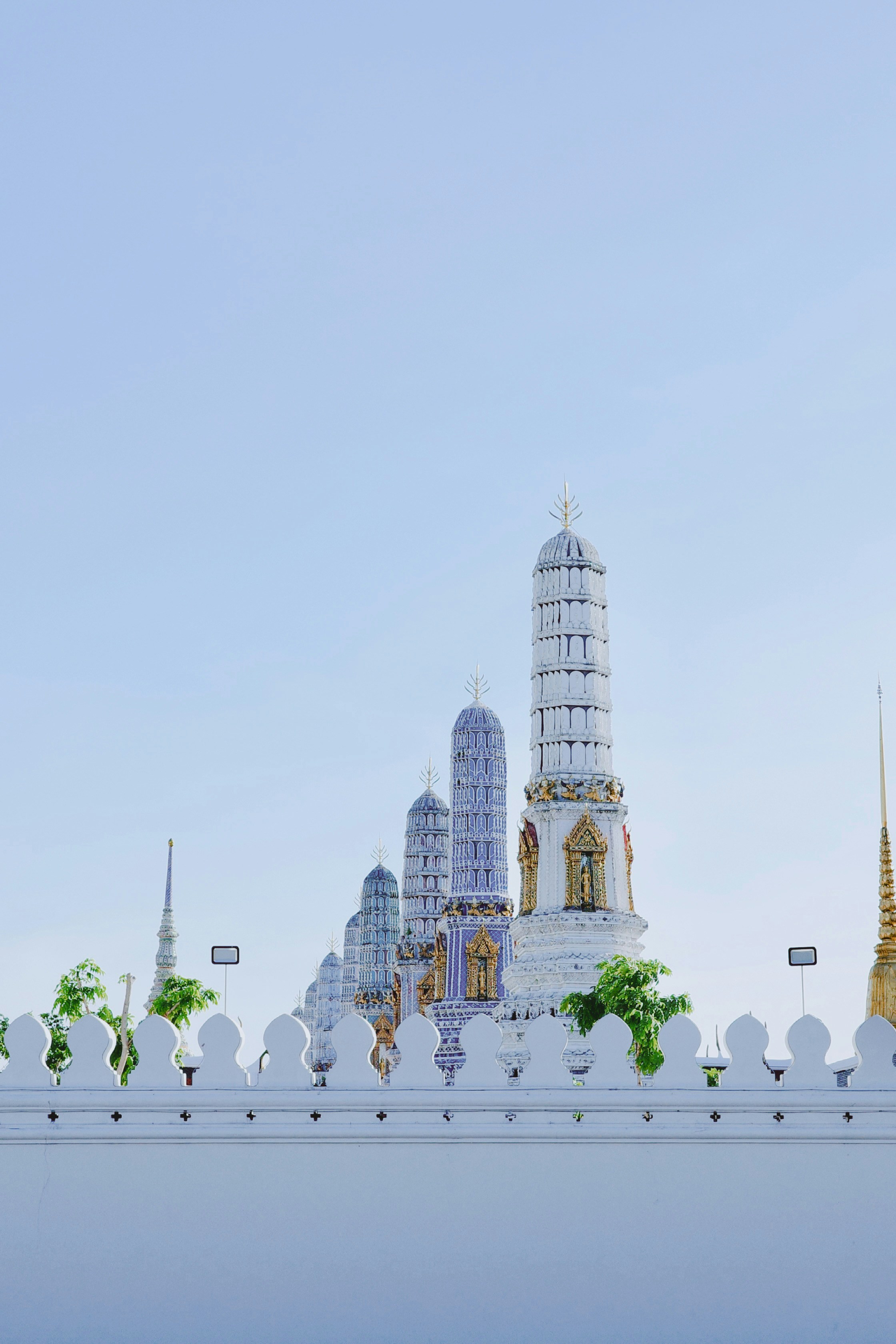 A white building with a clock tower in the background