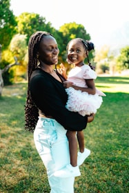 A woman holding a little girl in her arms