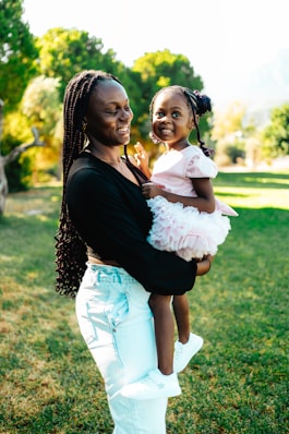 A woman holding a little girl in her arms
