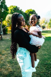 A woman holding a little girl in her arms