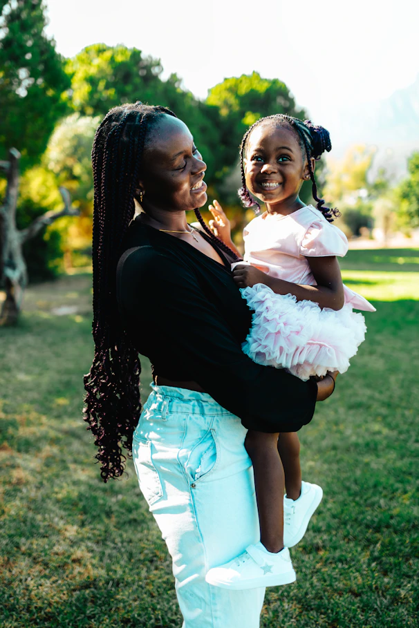 A woman holding a little girl in her arms