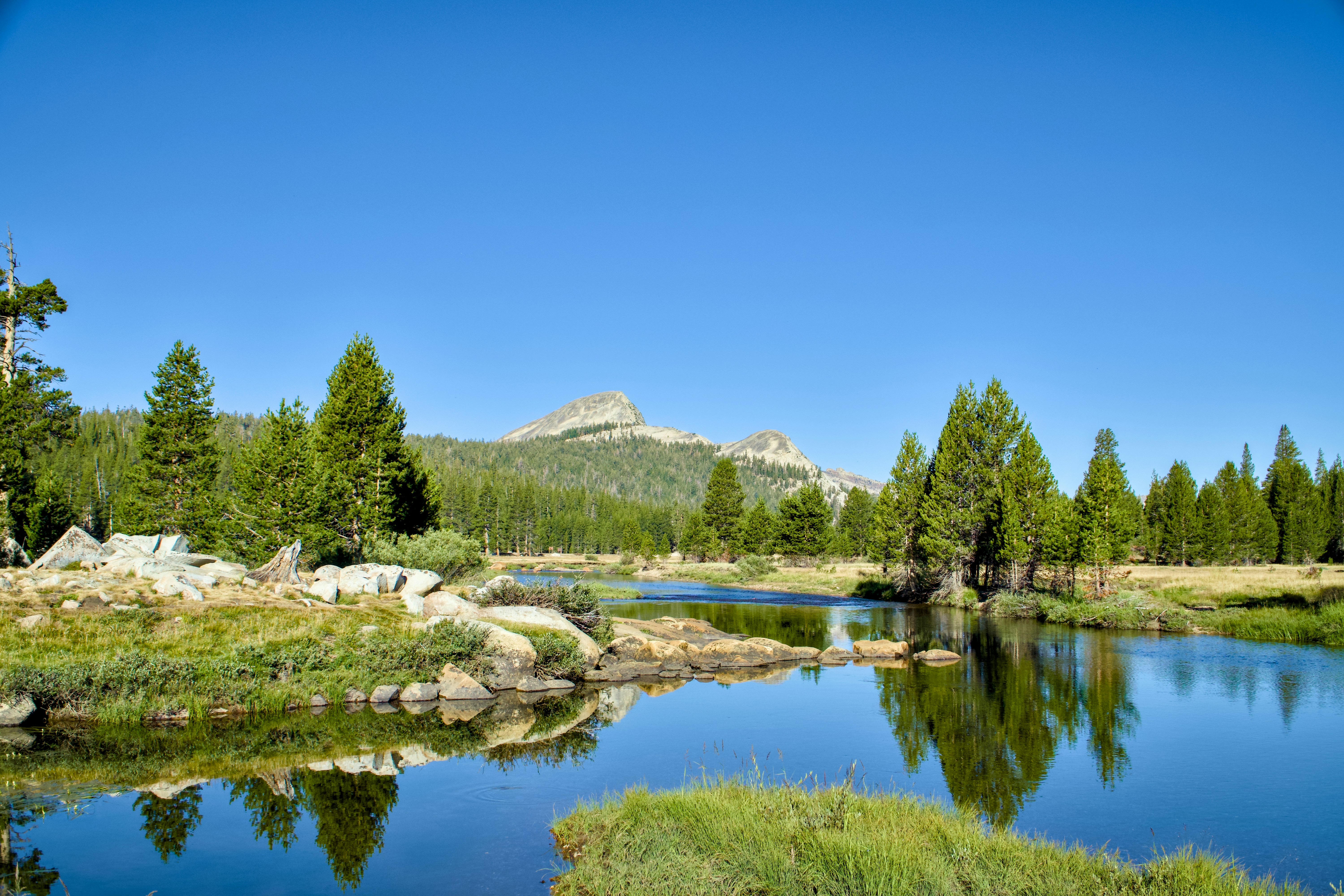 A lake surrounded by trees and mountains