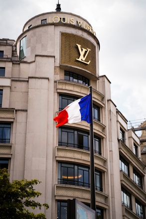 A very tall building with a flag flying in front of it