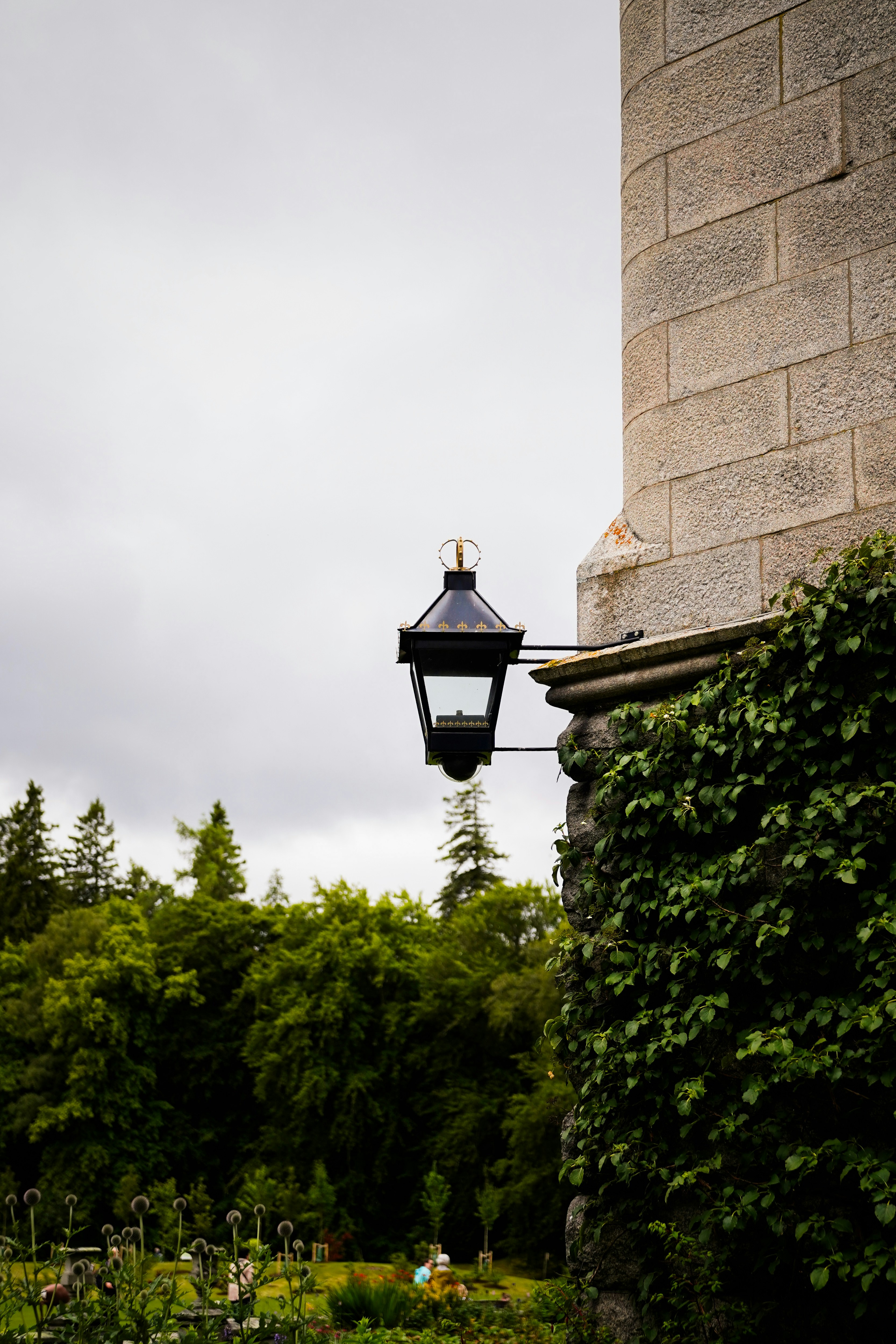 A lamp post next to a brick building