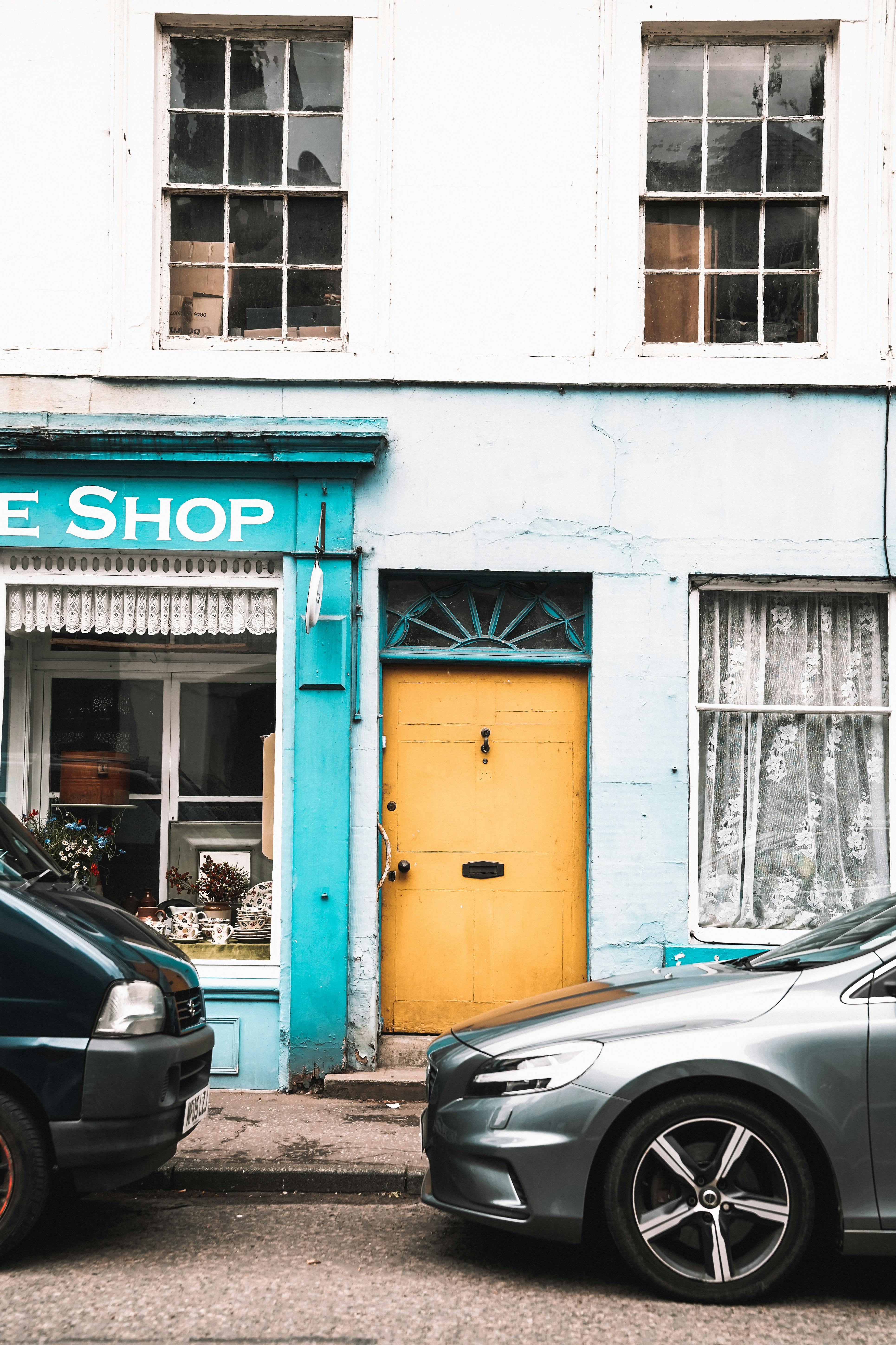 A couple of cars parked in front of a building