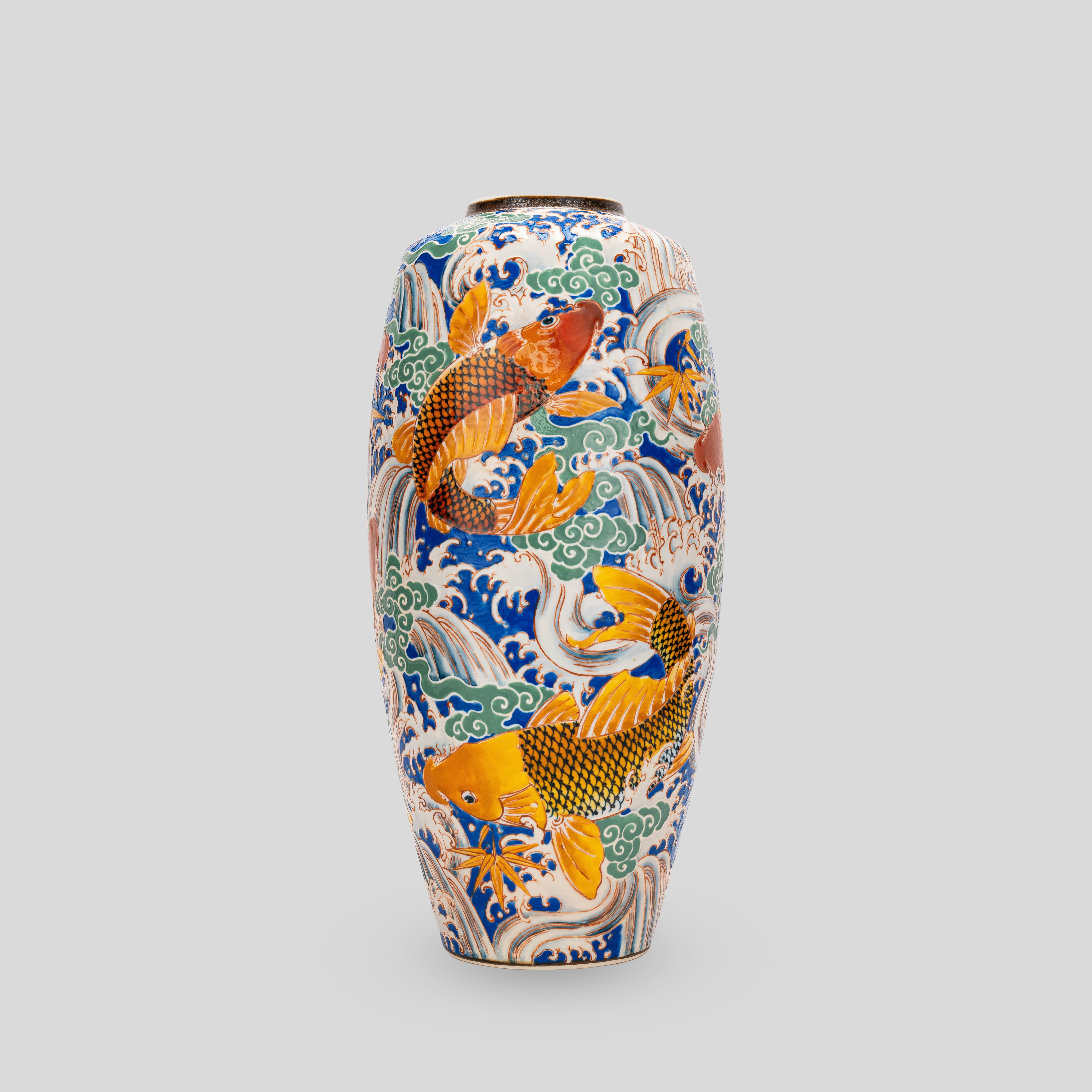 A vase with a fish design on it