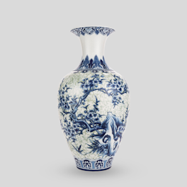 A blue and white vase sitting on top of a table