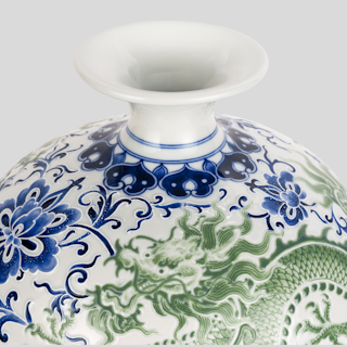 A blue and green vase with a dragon on it
