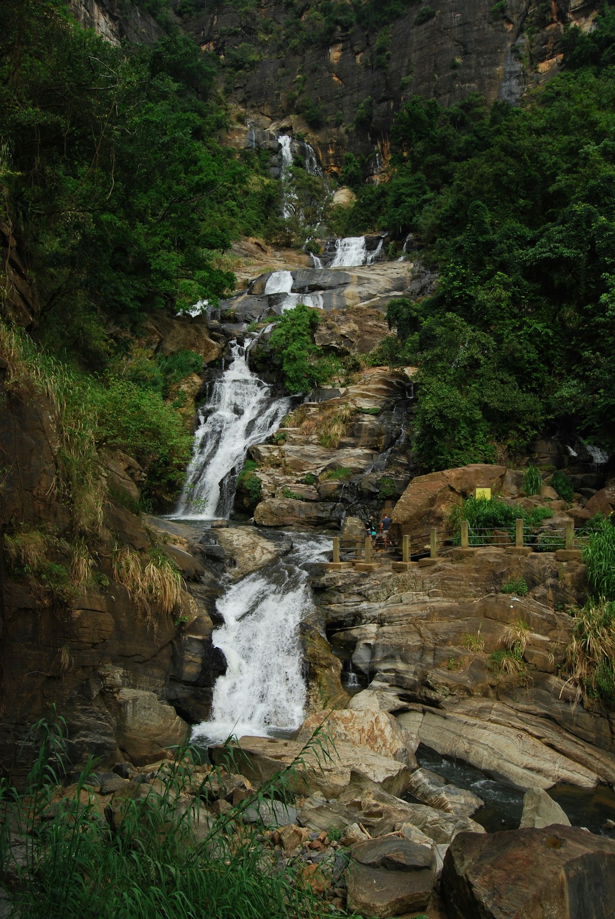 A dramatic Sri Lankan waterfall cascading down through lush green tropical jungle