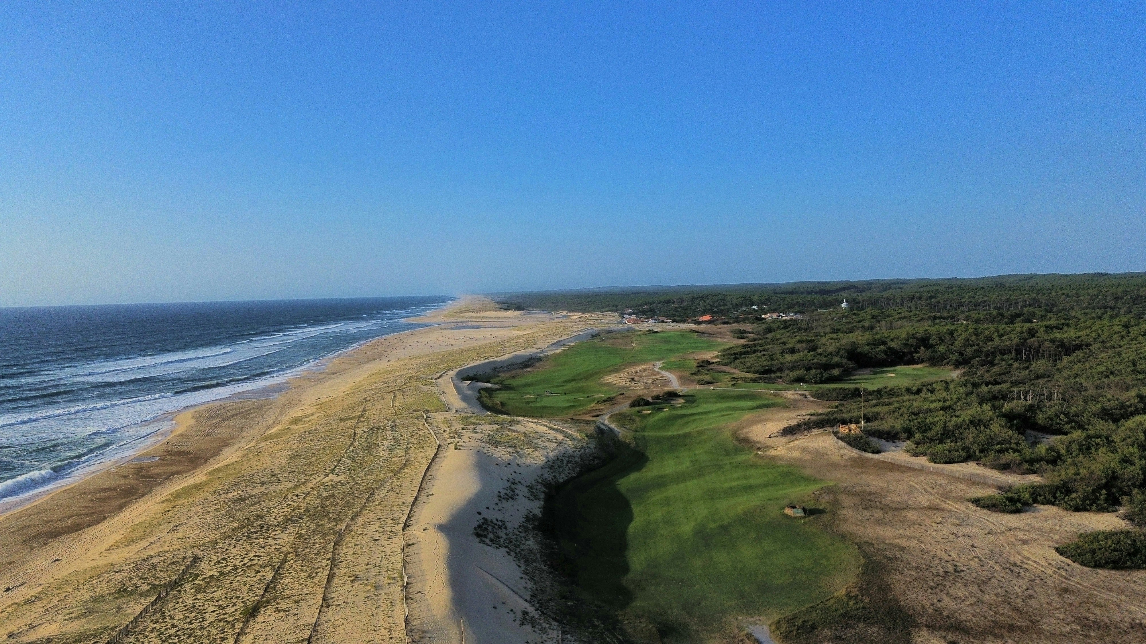 An aerial view of a sandy beach and ocean