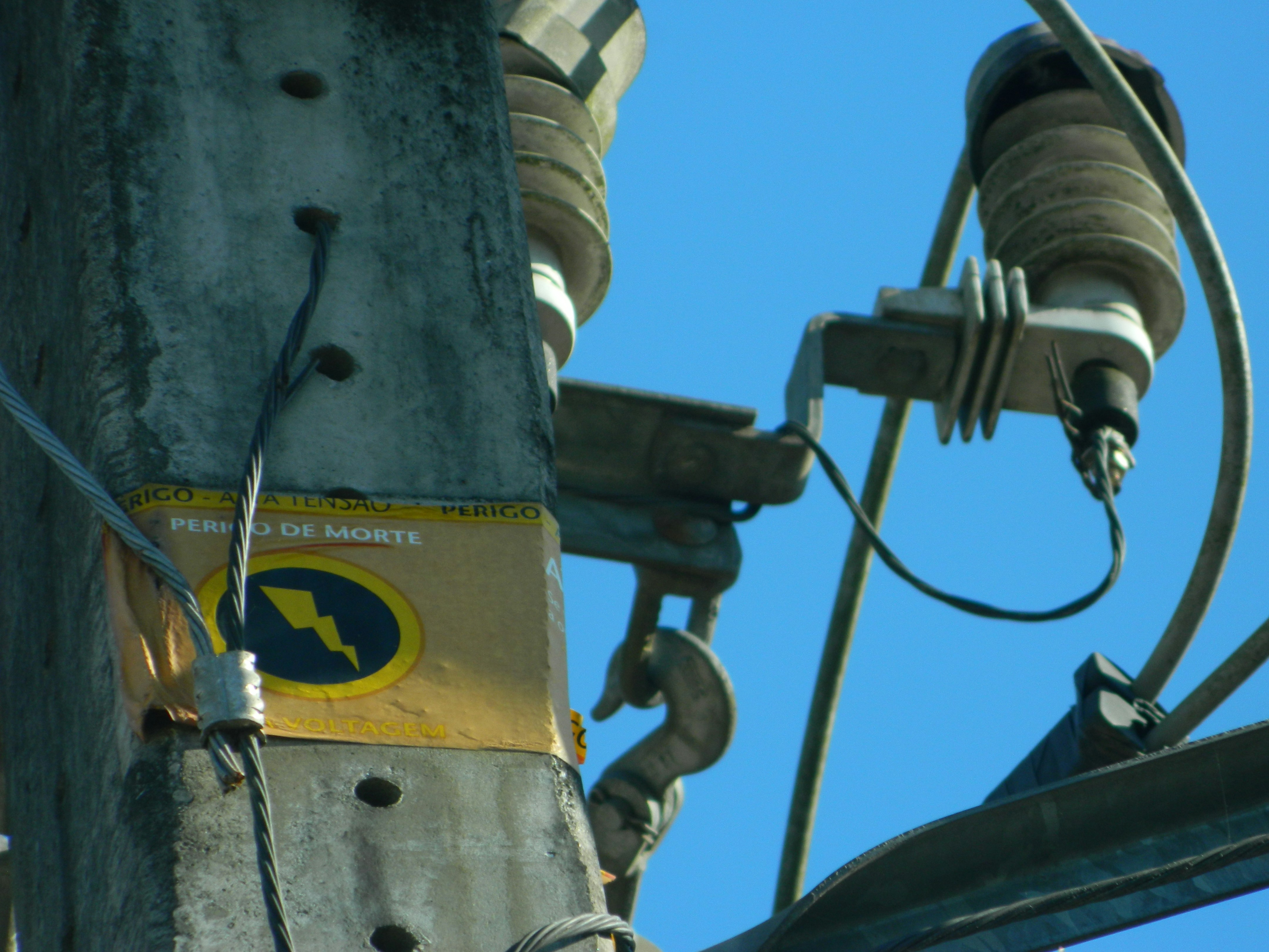 A close up of a power pole with wires attached to it