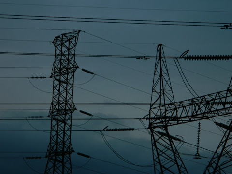 A group of power lines in the middle of the night