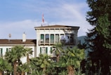 A large white building surrounded by palm trees