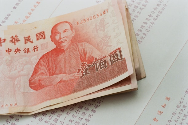A stack of chinese currency sitting on top of a table