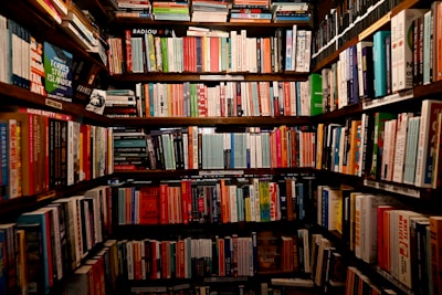 A bookshelf filled with lots of books in a library