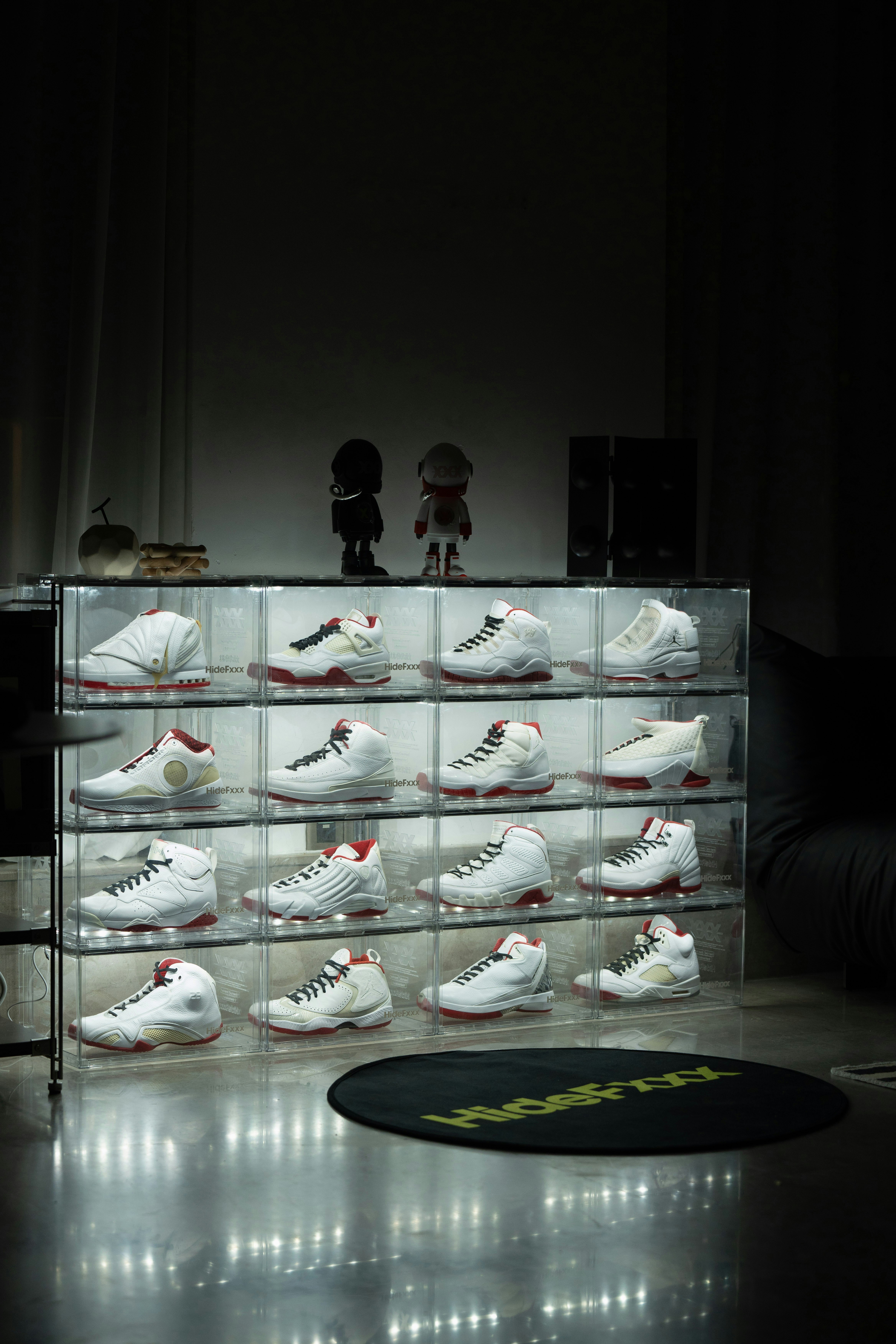 A large display case filled with shoes in a dark room