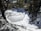 A frozen lake surrounded by trees and snow
