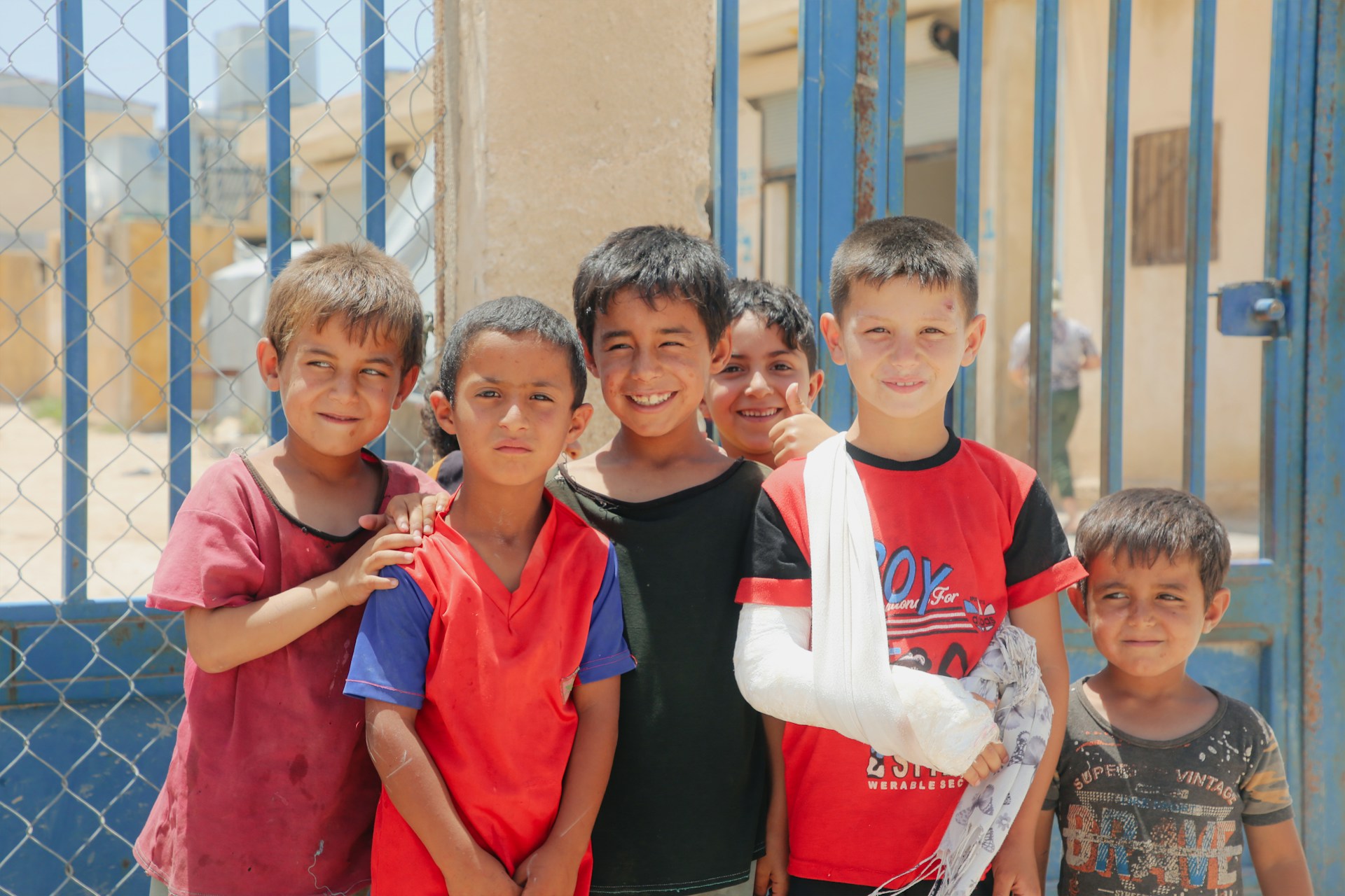 A group of young boys standing next to each other