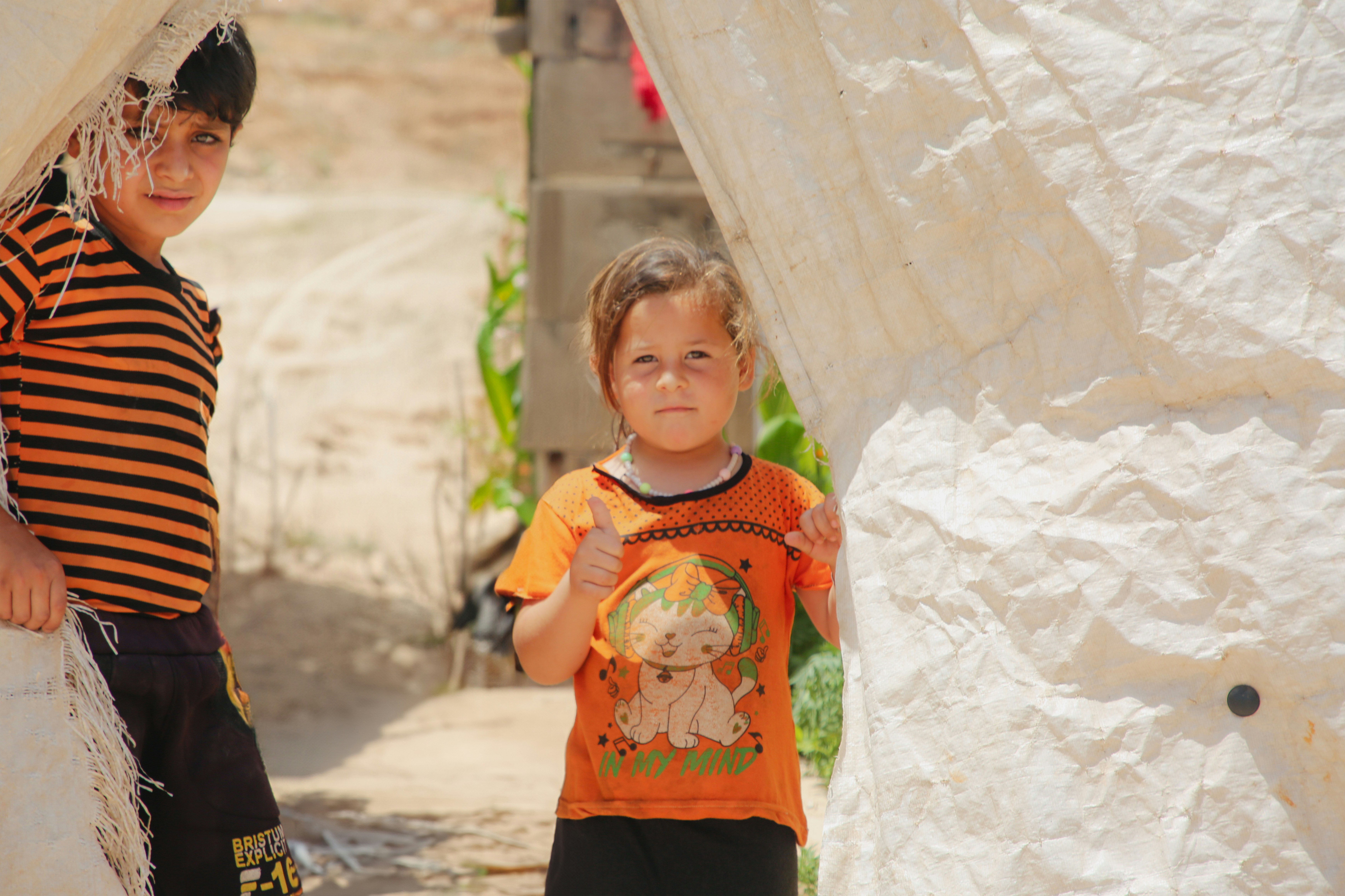 A couple of young boys standing next to each other