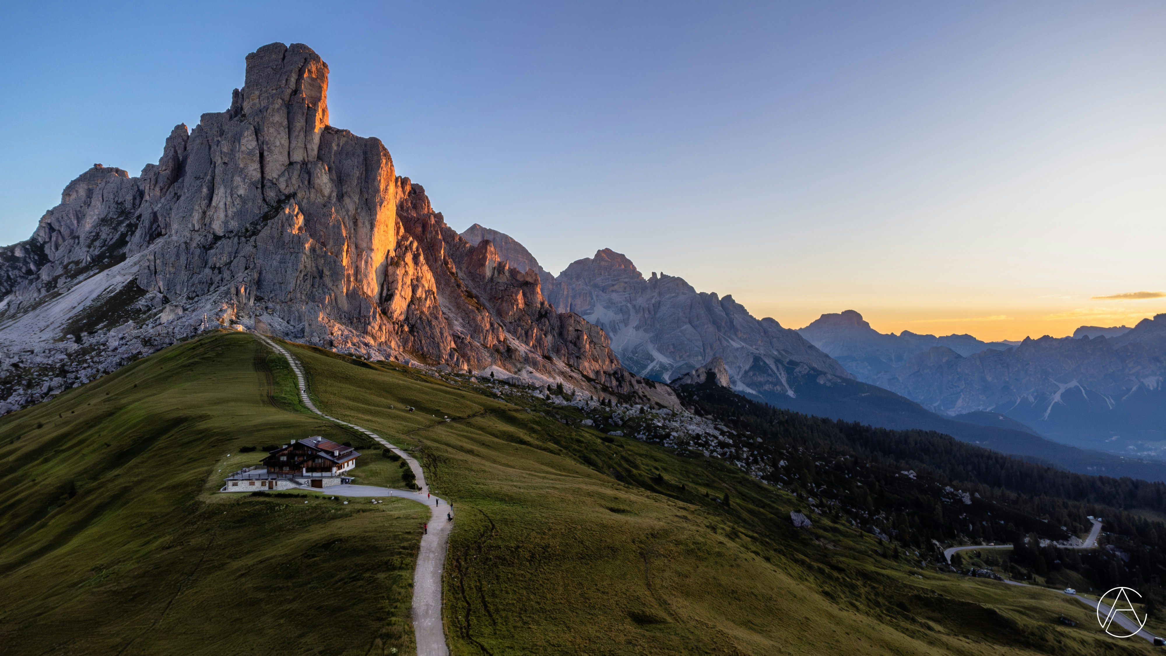A scenic view of a mountain with a road going up it