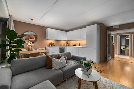 A living room filled with furniture and a wooden floor