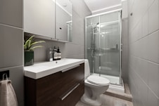 A bathroom with a toilet, sink, and shower