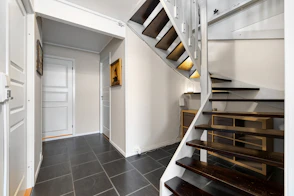 A staircase leading to a second floor bedroom