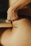 A woman with a tattoo on her stomach
