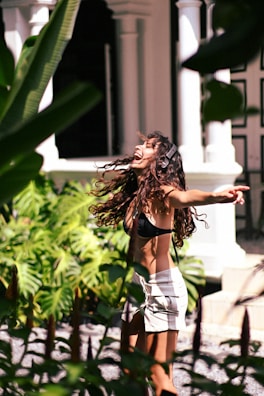 A woman in a bikini top is skateboarding
