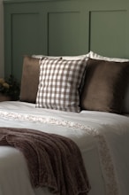 A bed with pillows and a blanket on top of it