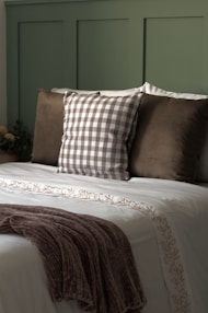 A bed with pillows and a blanket on top of it