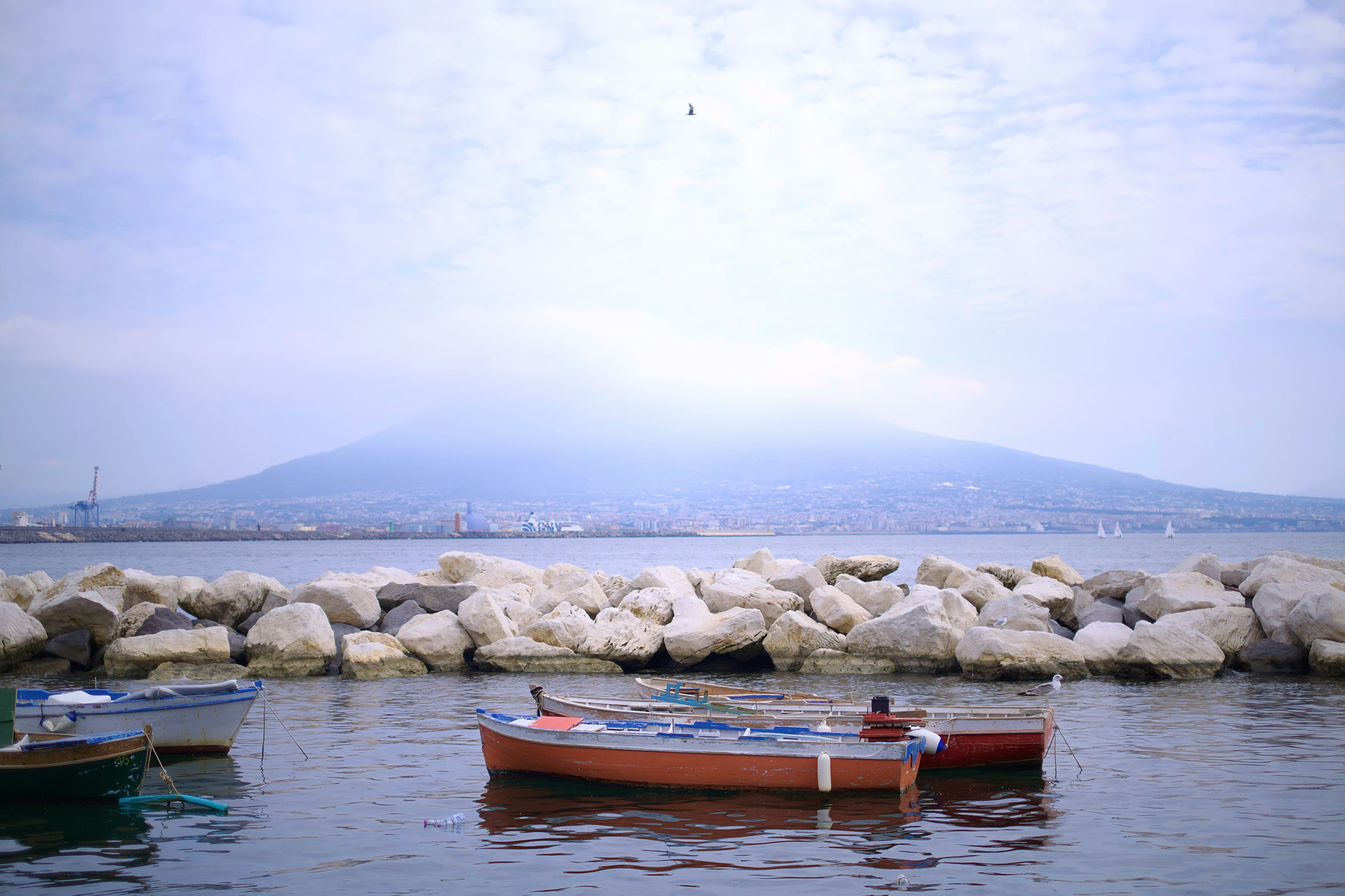 A couple of small boats floating on top of a body of water