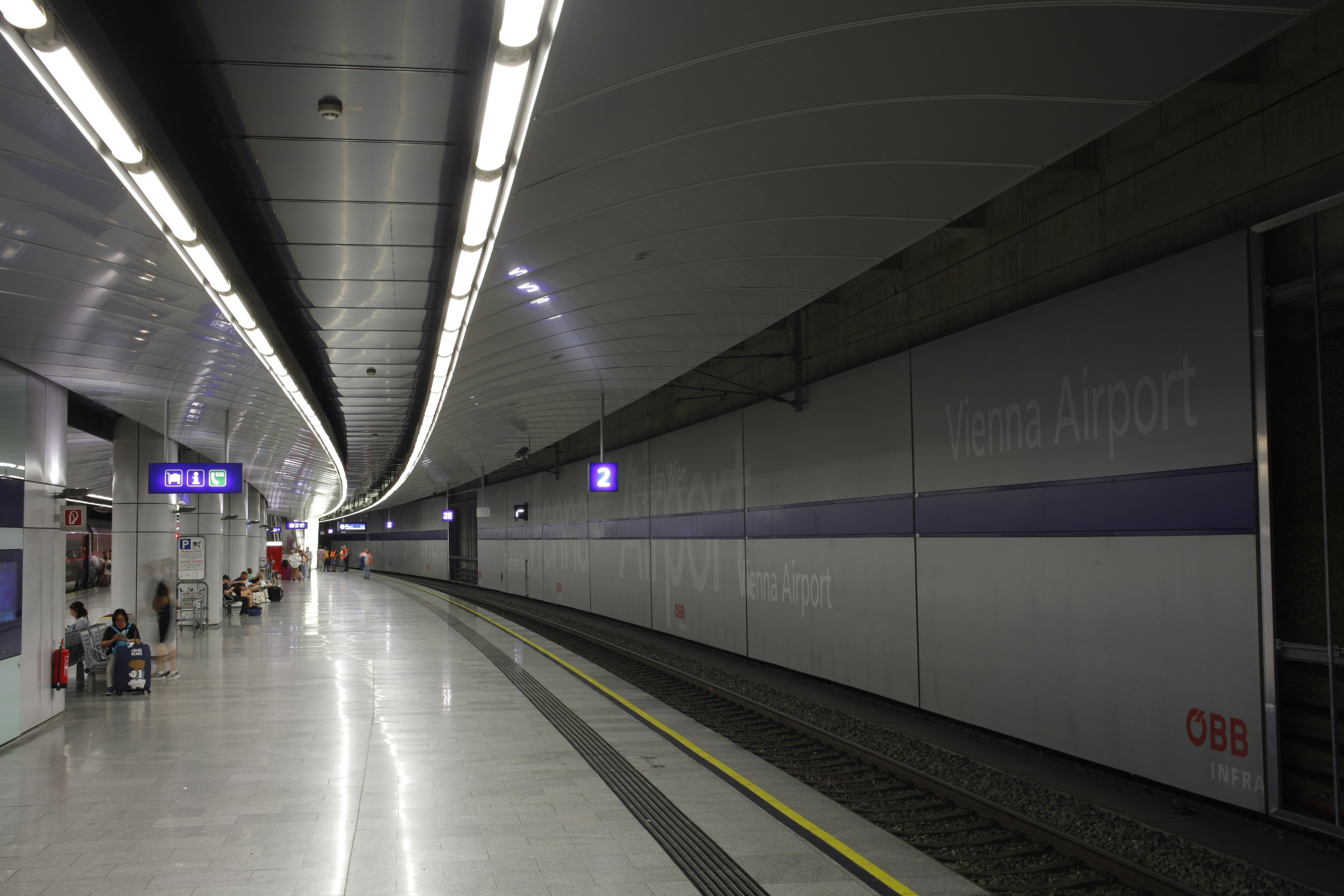 A subway station with people waiting for the train