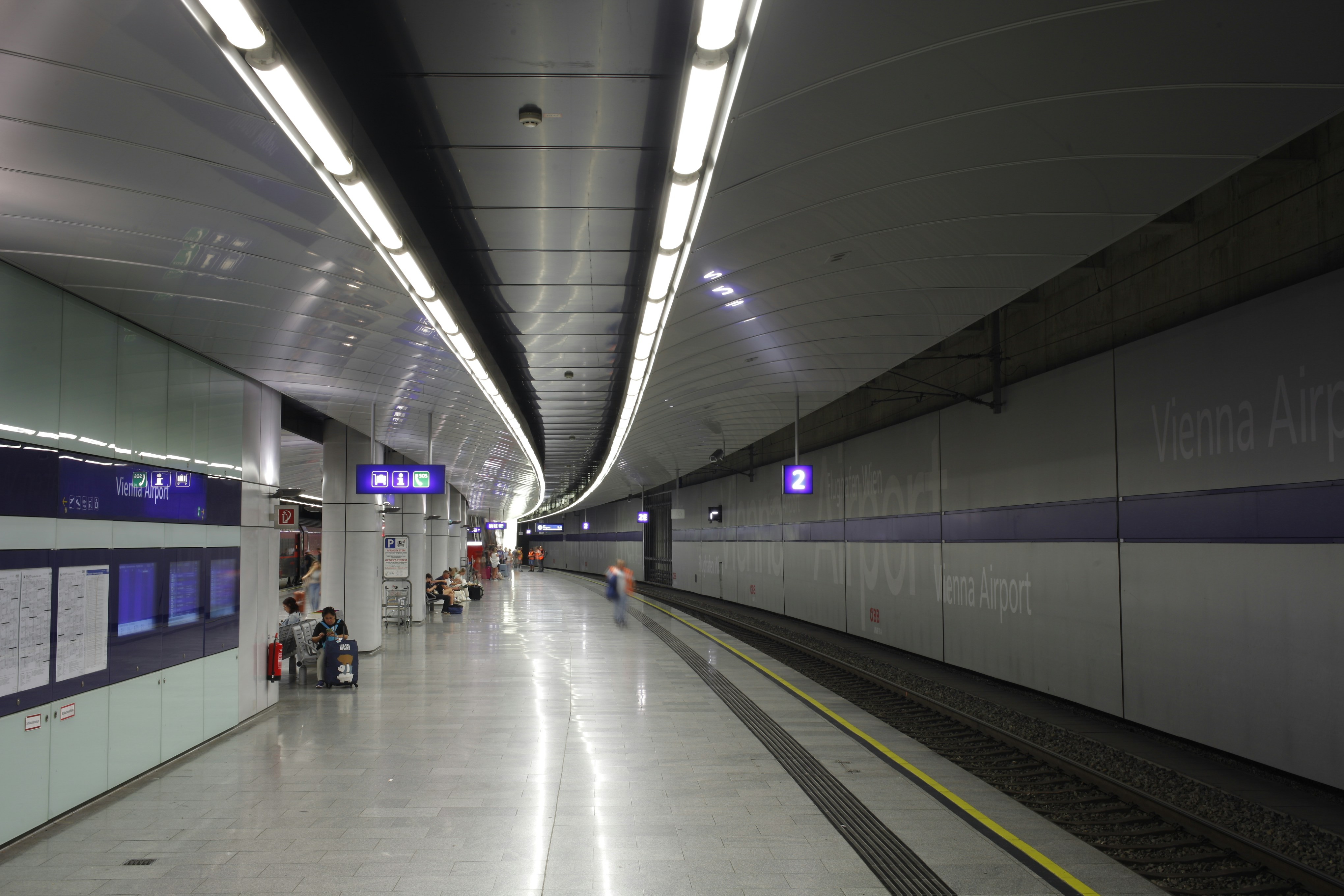 A subway station with people waiting for the train